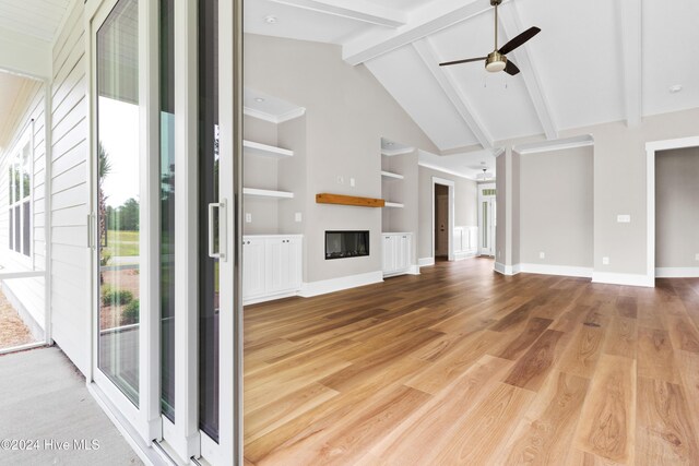 unfurnished living room with beam ceiling, light wood-type flooring, high vaulted ceiling, and ceiling fan