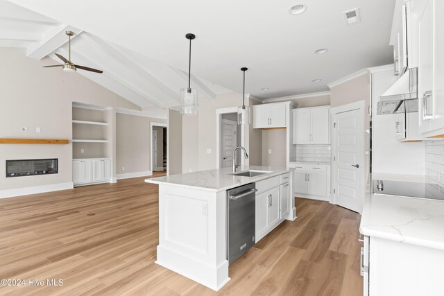 kitchen with stainless steel dishwasher, white cabinetry, and sink