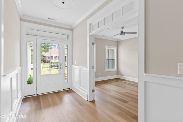 entryway featuring crown molding, ceiling fan, and light wood-type flooring