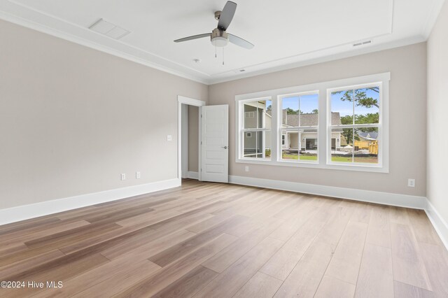 unfurnished room with ceiling fan, ornamental molding, and light hardwood / wood-style flooring