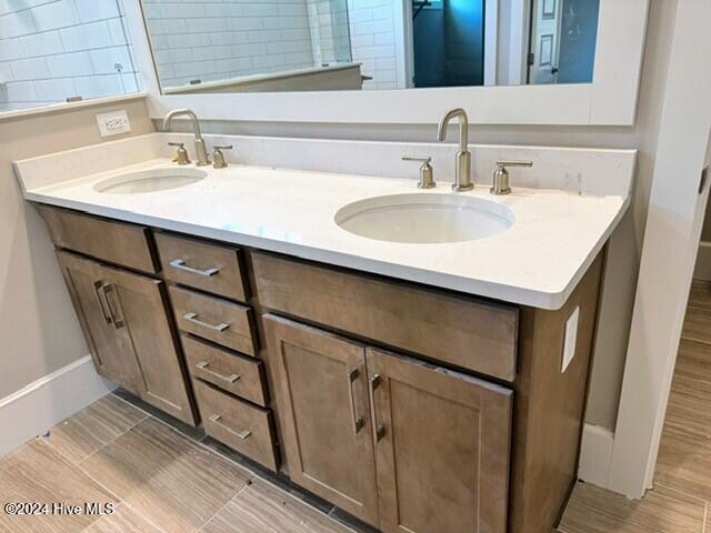 bathroom with hardwood / wood-style floors and vanity