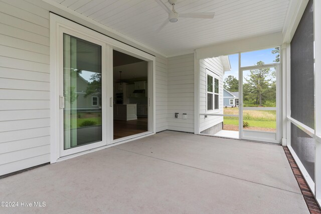 unfurnished sunroom featuring ceiling fan