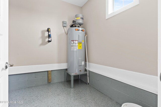 utility room with electric water heater