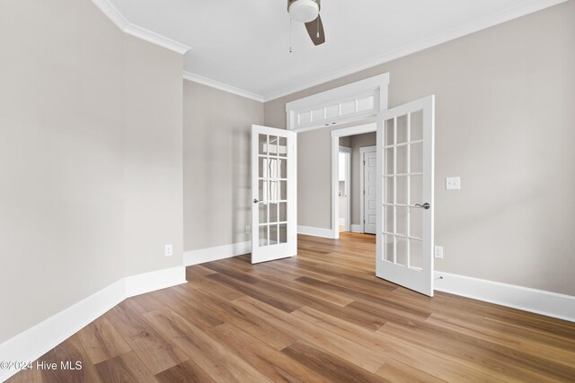 unfurnished room with ceiling fan, french doors, ornamental molding, and hardwood / wood-style flooring