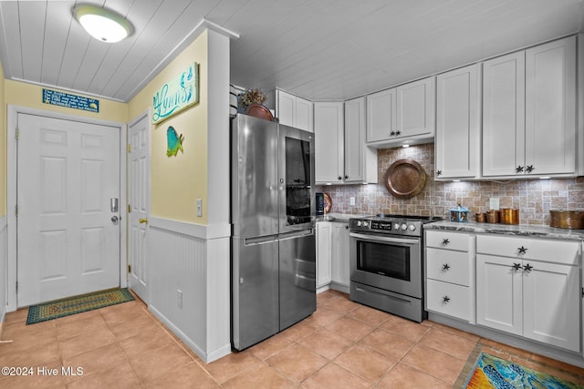 kitchen featuring white cabinetry, light tile patterned flooring, and appliances with stainless steel finishes