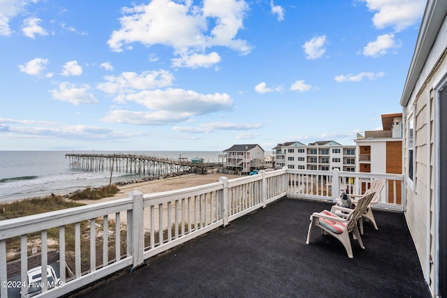 view of patio with a water view and a view of the beach