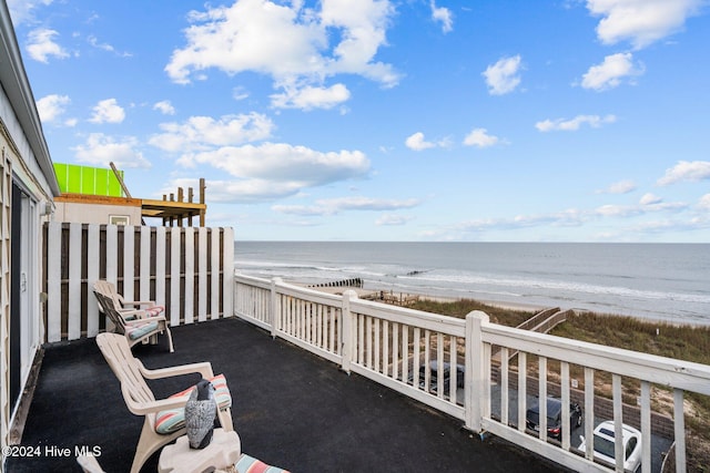 exterior space with a water view and a view of the beach