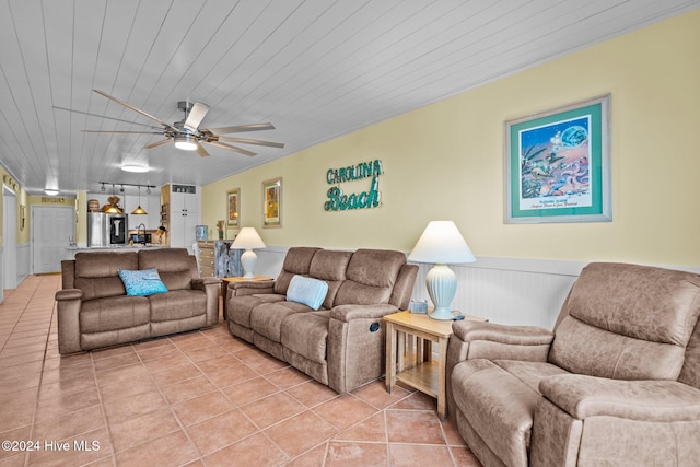 living room with ceiling fan, light tile patterned floors, and wooden ceiling