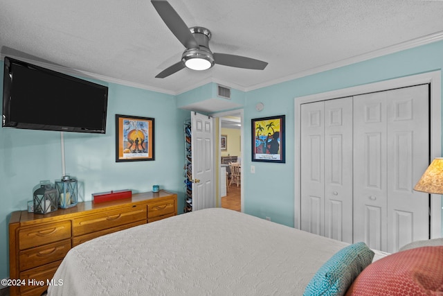 bedroom with a textured ceiling, a closet, crown molding, and ceiling fan