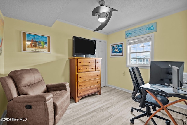 office space with a textured ceiling, light hardwood / wood-style flooring, ceiling fan, and ornamental molding