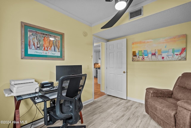 office featuring ceiling fan, light hardwood / wood-style floors, a textured ceiling, and ornamental molding