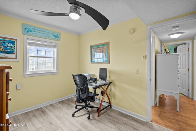 office area with ceiling fan, crown molding, a textured ceiling, and light wood-type flooring