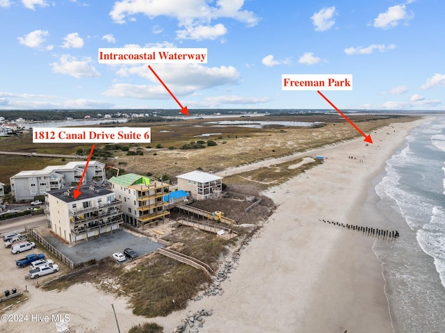 birds eye view of property with a view of the beach and a water view