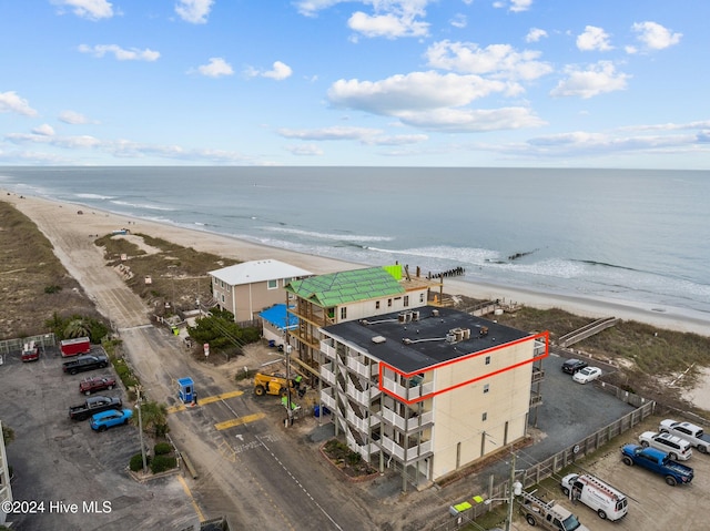 drone / aerial view featuring a water view and a beach view