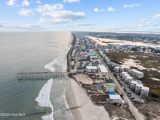 bird's eye view featuring a water view and a beach view