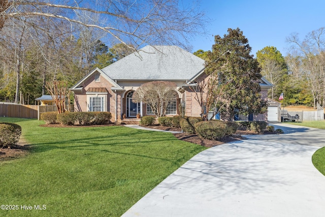 view of front of property featuring a front lawn and a garage