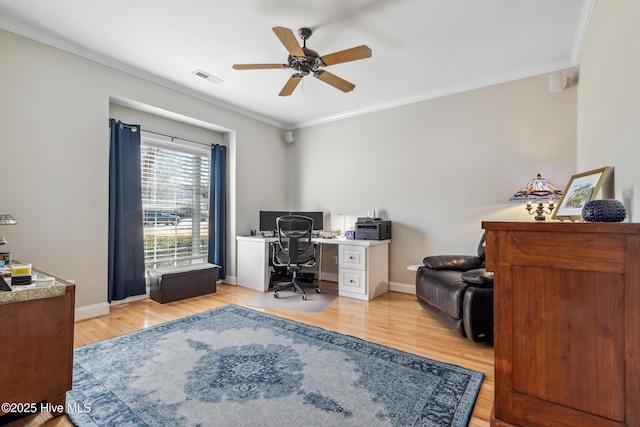 office space with ceiling fan, ornamental molding, and light wood-type flooring