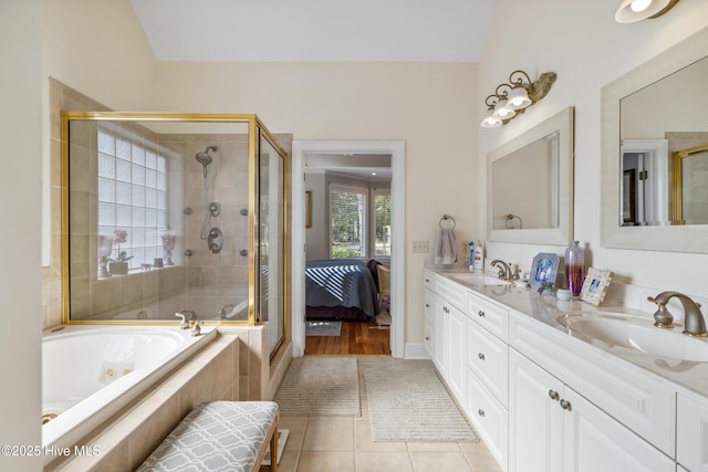 bathroom with shower with separate bathtub, tile patterned floors, and vanity