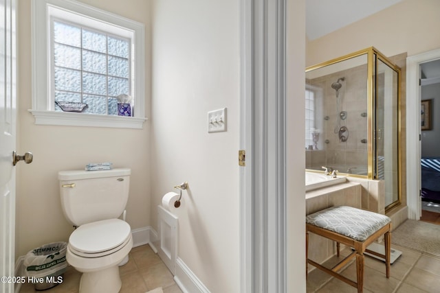 bathroom featuring toilet, shower with separate bathtub, and tile patterned floors