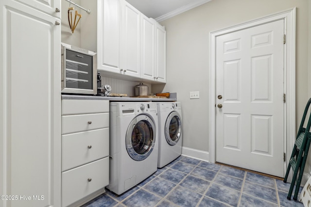 washroom with independent washer and dryer, crown molding, and cabinets