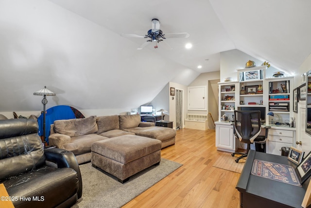 living room with vaulted ceiling, ceiling fan, and light hardwood / wood-style flooring