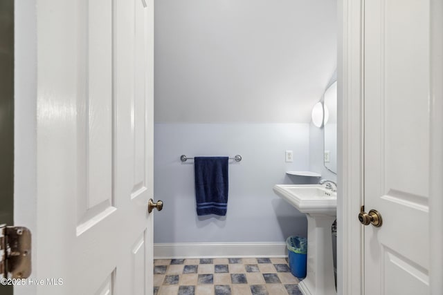 bathroom featuring vaulted ceiling