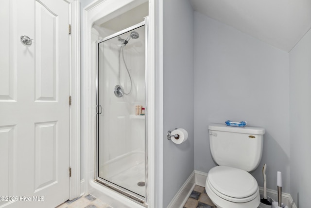 bathroom featuring walk in shower and toilet