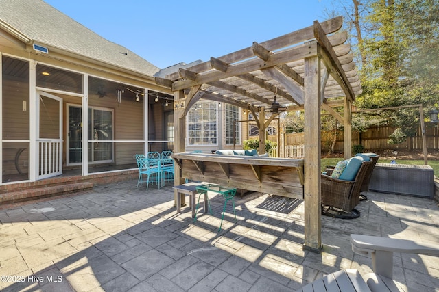 view of patio featuring ceiling fan, a pergola, and a bar