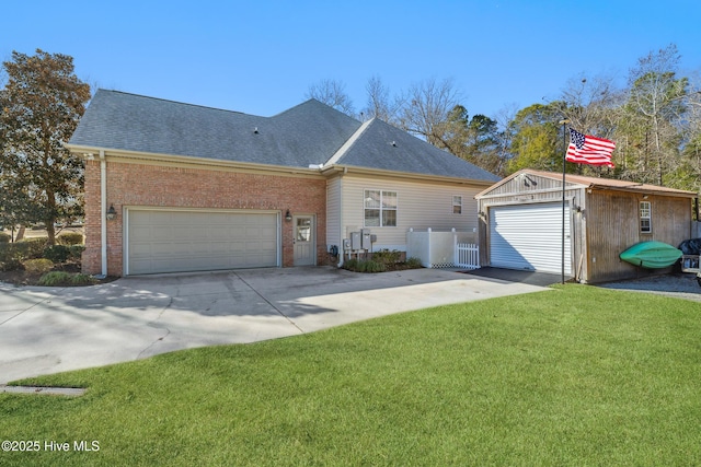 ranch-style house with an outbuilding, a garage, and a front yard