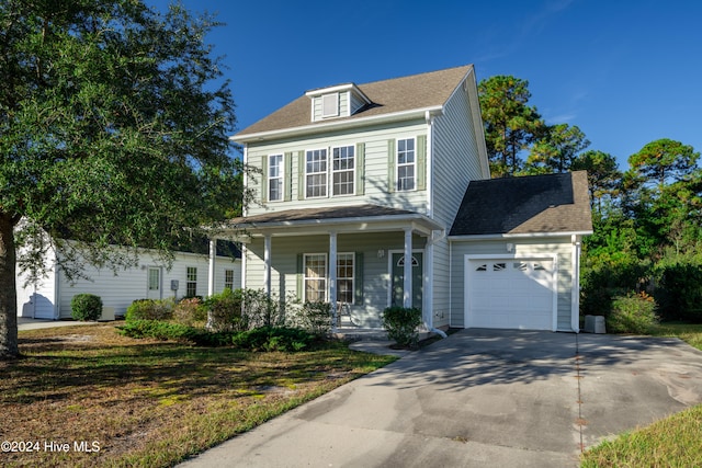 view of front of property with covered porch and a garage