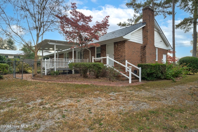 back of property featuring a porch and a lawn