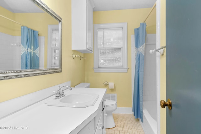 full bathroom with shower / bath combo with shower curtain, tile patterned flooring, vanity, and toilet