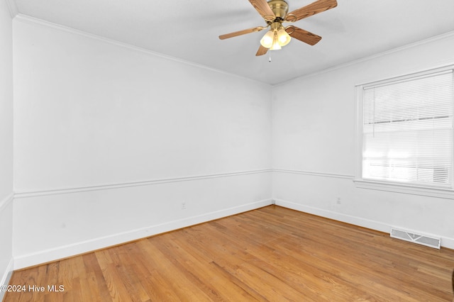 spare room with hardwood / wood-style flooring, ceiling fan, and crown molding