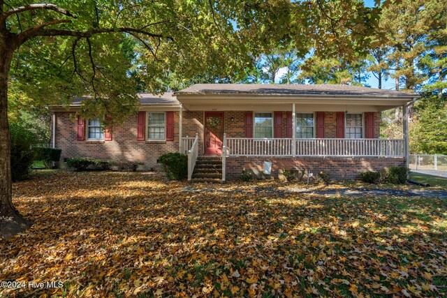 ranch-style home featuring covered porch