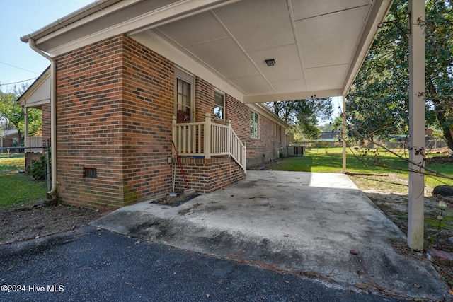 view of home's exterior with a lawn and central AC