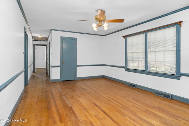 unfurnished room with ceiling fan, light hardwood / wood-style flooring, and crown molding