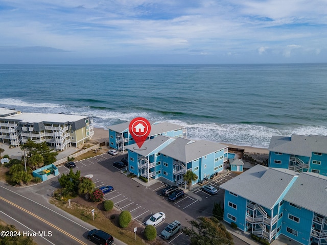 birds eye view of property featuring a beach view and a water view