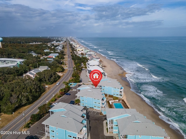 birds eye view of property featuring a beach view and a water view