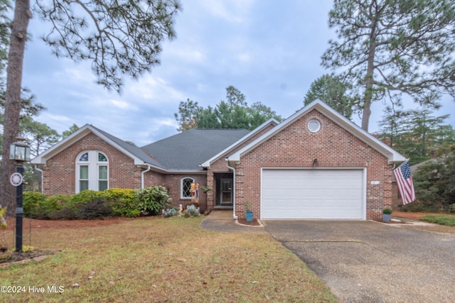 view of front facade featuring a garage and a front lawn