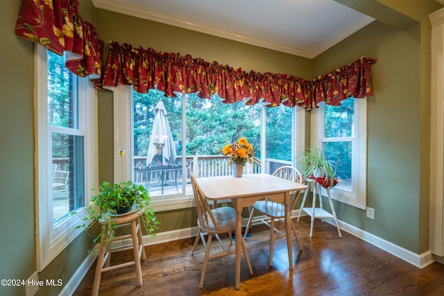 dining area featuring dark hardwood / wood-style flooring, plenty of natural light, and crown molding