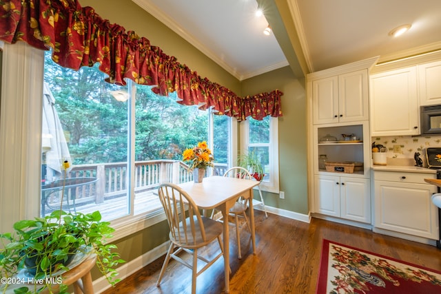 dining space with dark hardwood / wood-style floors and crown molding