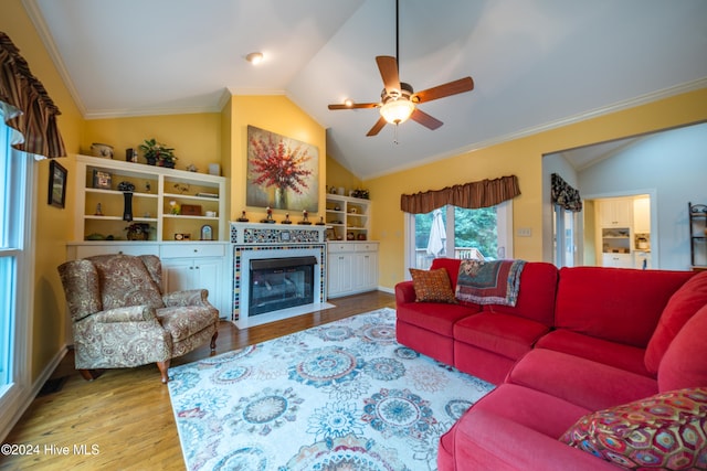 living room featuring ceiling fan, wood-type flooring, lofted ceiling, and ornamental molding