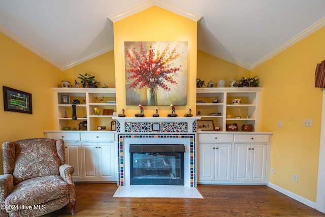 living area with crown molding, lofted ceiling, and hardwood / wood-style flooring