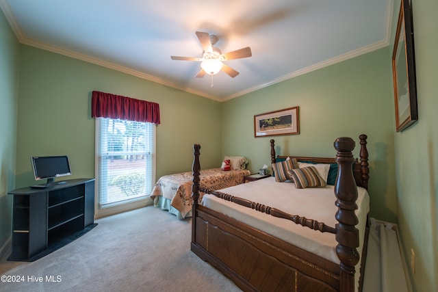 carpeted bedroom featuring ceiling fan and crown molding