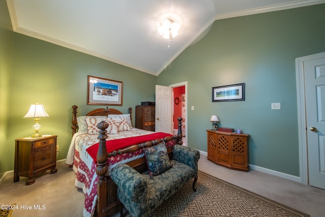 carpeted bedroom with ornamental molding and high vaulted ceiling