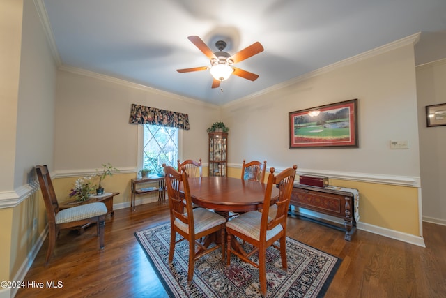 dining room featuring crown molding, ceiling fan, and dark wood-type flooring