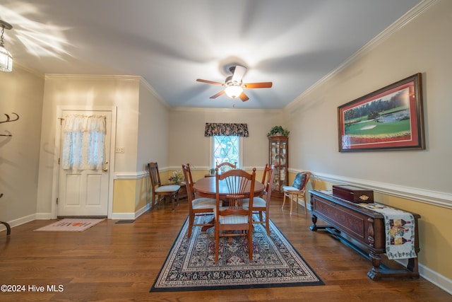 dining space with ceiling fan, dark wood-type flooring, and ornamental molding