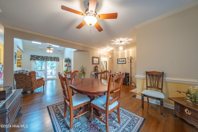 dining space with lofted ceiling, dark hardwood / wood-style flooring, ceiling fan, and crown molding