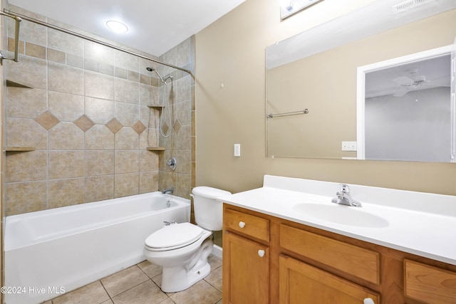 full bathroom with ceiling fan, tiled shower / bath combo, tile patterned floors, toilet, and vanity