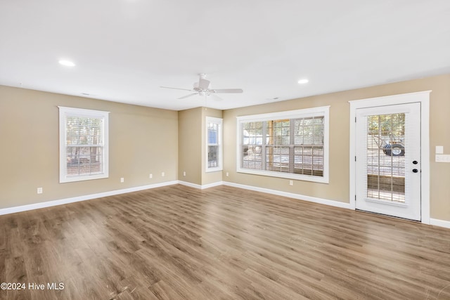 unfurnished living room featuring hardwood / wood-style flooring and ceiling fan